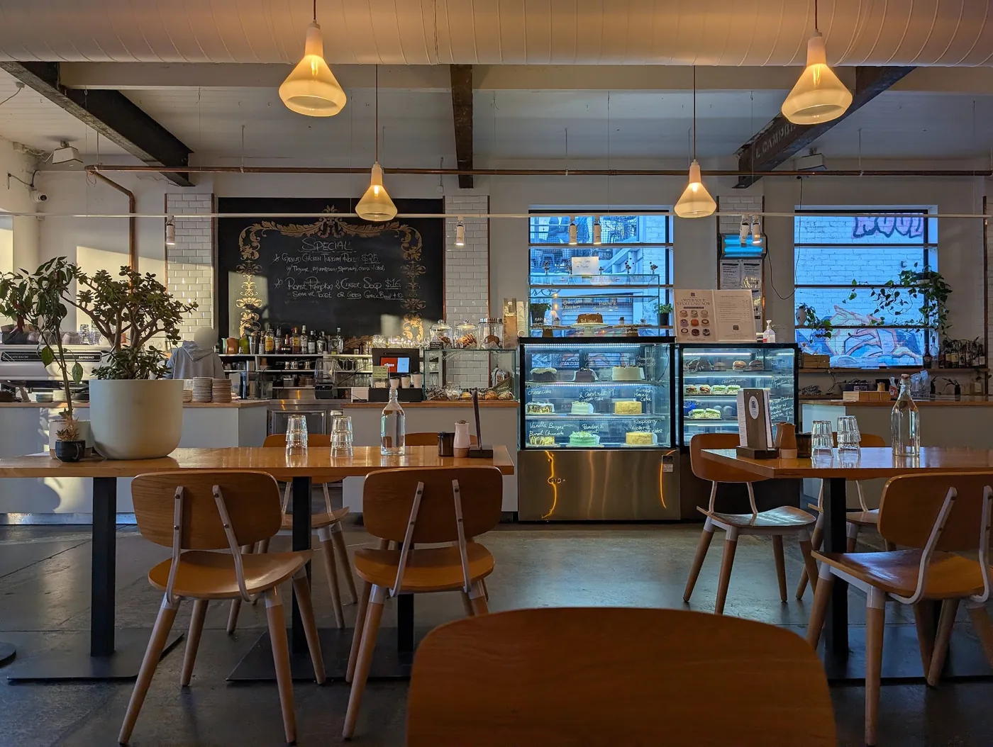 The dining room with the glass cake cabinets and chalkboard menus