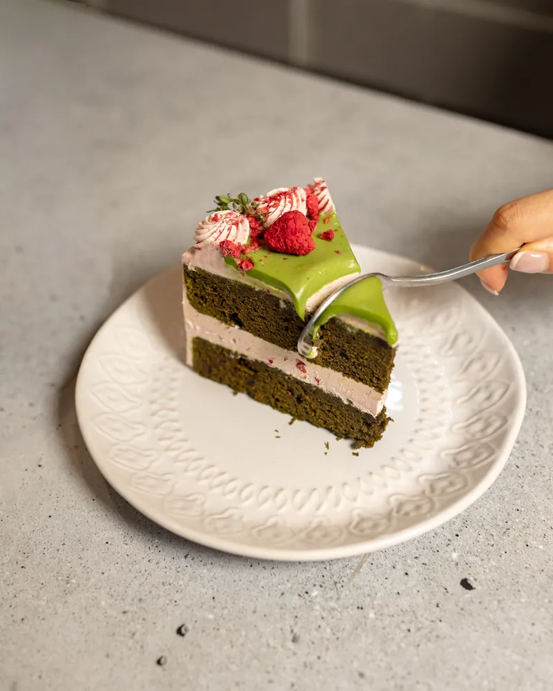 A slice of pandan strawberry cake